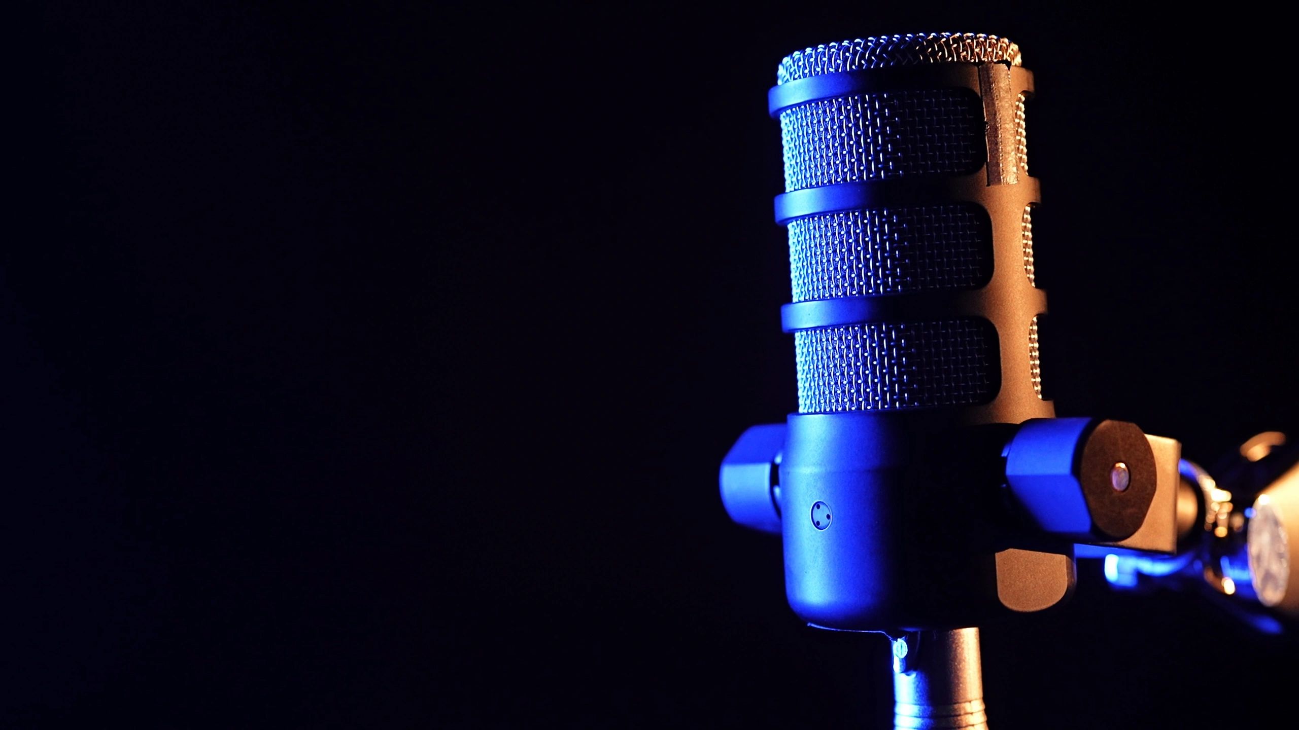 Studio microphone lit with dramatic yellow and blue lighting