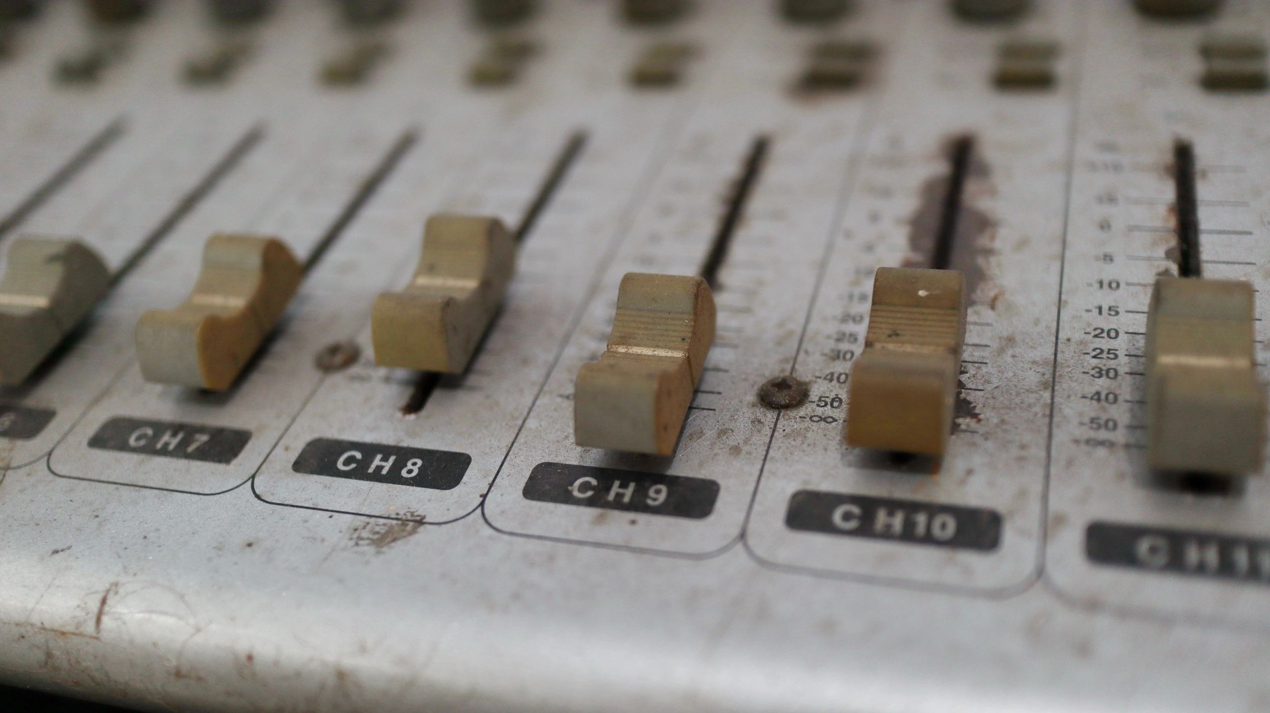 Vintage audio mixer controls in a studio